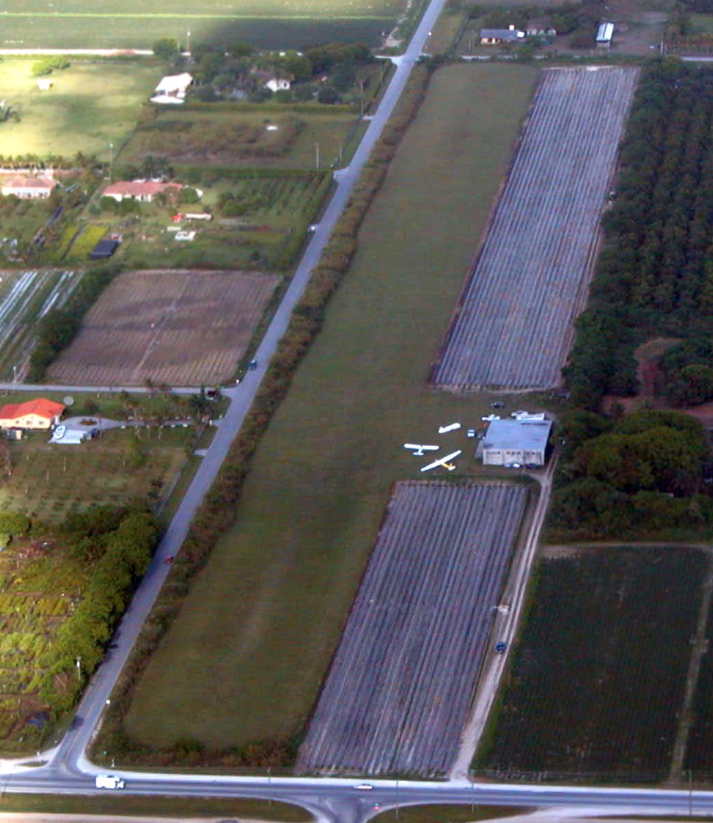 Miami Gliderport, 2003: aerial looking east along the grass strip with the hangar, sailplanes, and adjacent farm fields