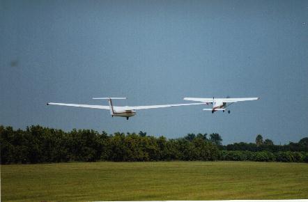 Glider on tow behind a towplane just after liftoff at Richard's Field, summer 2001